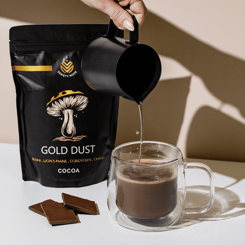 Hot water being poured into a cup beside a Gold Dust pouch.